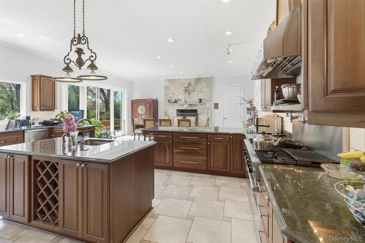 Spacious kitchen featuring two large islands with integrated wine storage and a sink