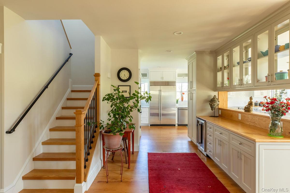 Entrance foyer, with view of the staircase and wet bar