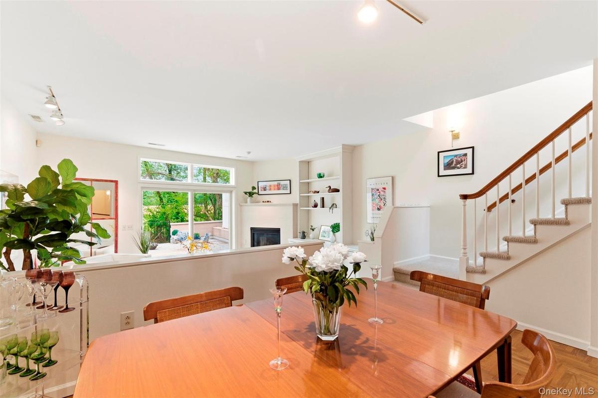 Open-concept dining-living room with high ceilings.