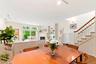 Open-concept dining-living room with high ceilings.