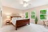 Primary Bedroom with seasonal river views, high ceilings & marble en-suite bath.