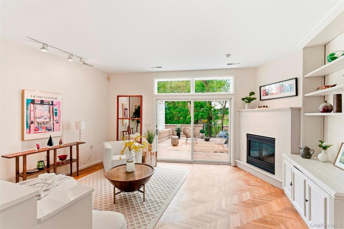 Sunny, open-concept living room with deck access.