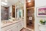 Marble en suite bath with dual sinks and separate shower.