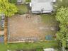 Expansive cleared lot enclosed by perimeter fencing