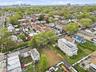 Cleared lot presenting a development opportunity, bordered by existing residential structures