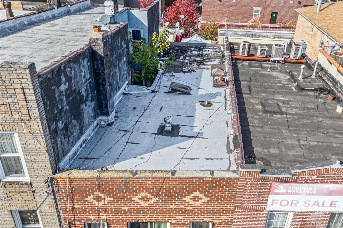 Exterior view of brick siding and a cooling unit