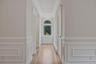 Primary bedroom hallway with entrances to bathroom and walk in closet