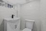 Bathroom with vanity and tile walls