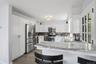 Wood cabinetry. Granit CT. S/S GE appliances. Gas stove, dishwasher, microwave, double door refrigerator.