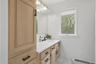 Main floor full bathroom. Wood cabinetry. Granite CT. Walk in tile shower.