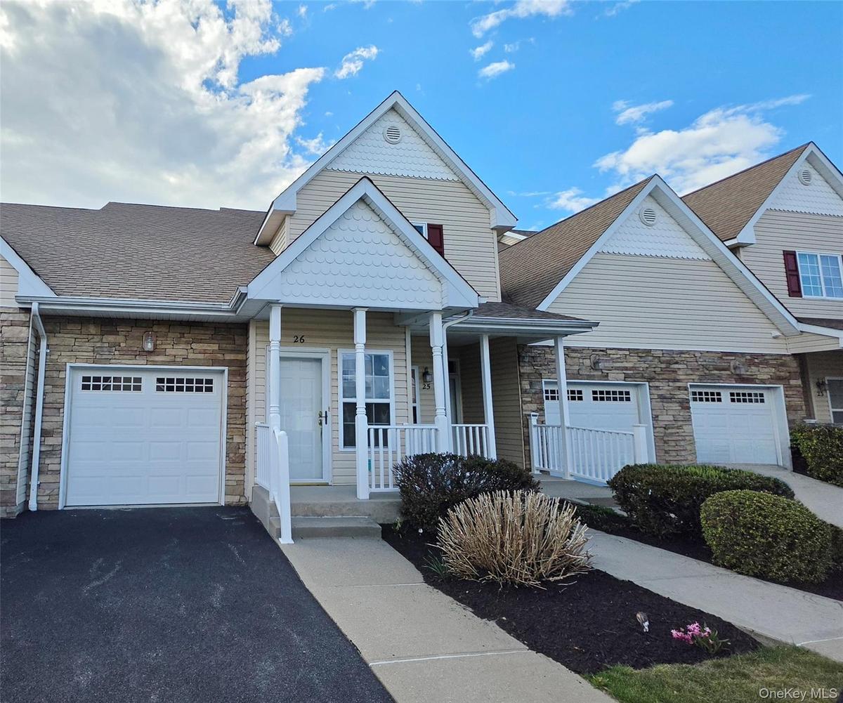 Exterior View showcasing Front Porch and Attached Garage