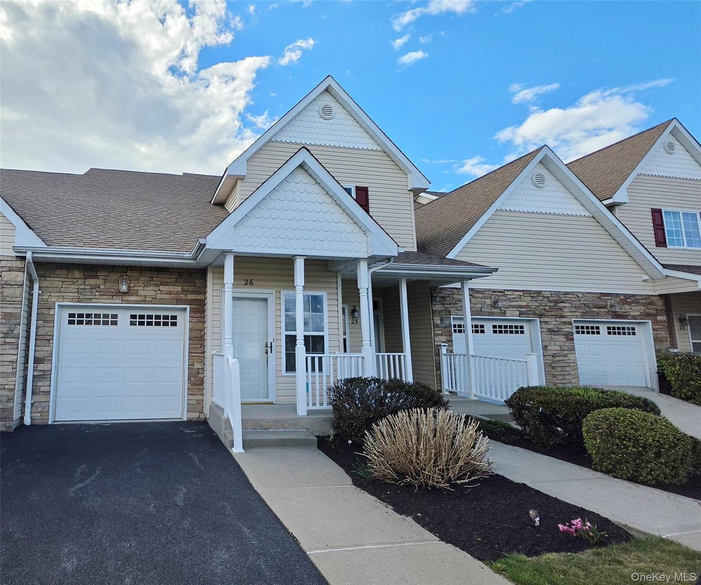 Exterior View showcasing Front Porch and Attached Garage