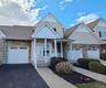 Exterior View showcasing Front Porch and Attached Garage