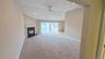 Spacious Living room with gas fireplace and French door style sliders leading to large balcony.