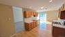View of kitchen from dining area with doorway leading to living room