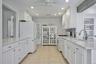 Modern kitchen featuring white cabinetry, light-toned countertops, and tile flooring