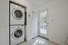 Dedicated laundry area featuring a stacked washer and dryer