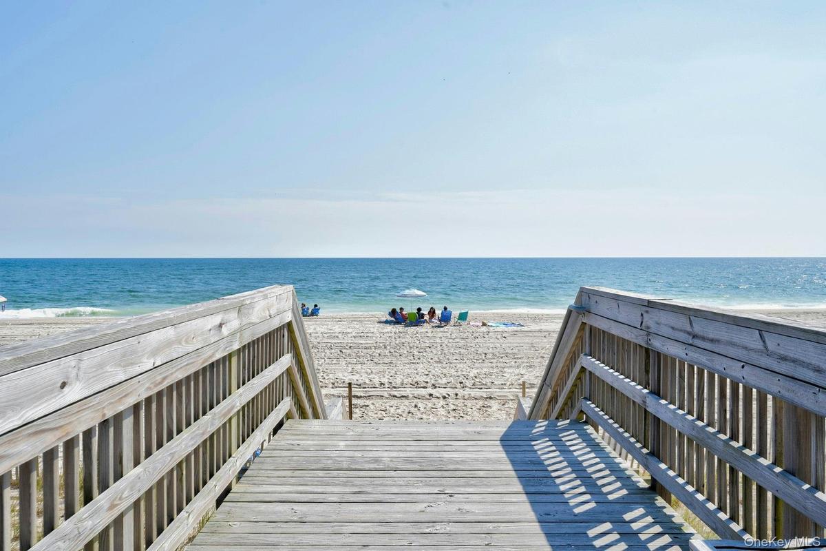Wooden boardwalk access leading to a sandy beach