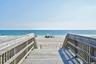 Wooden boardwalk access leading to a sandy beach