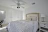Bedroom featuring a ceiling fan with integrated lighting, multiple paneled closet doors, and recessed lighting