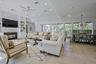 Open concept living space featuring a built-in media center with fireplace, recessed lighting, a ceiling fan, and light-toned tile flooring