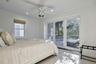 Room featuring a white ceiling fan with integrated lighting, recessed lighting, and a window with a woven shade