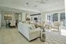 Spacious living area featuring light tile flooring, recessed lighting, and a ceiling fan