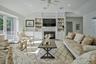 Living area featuring vaulted ceilings, fireplace, recessed lighting, and a ceiling fan