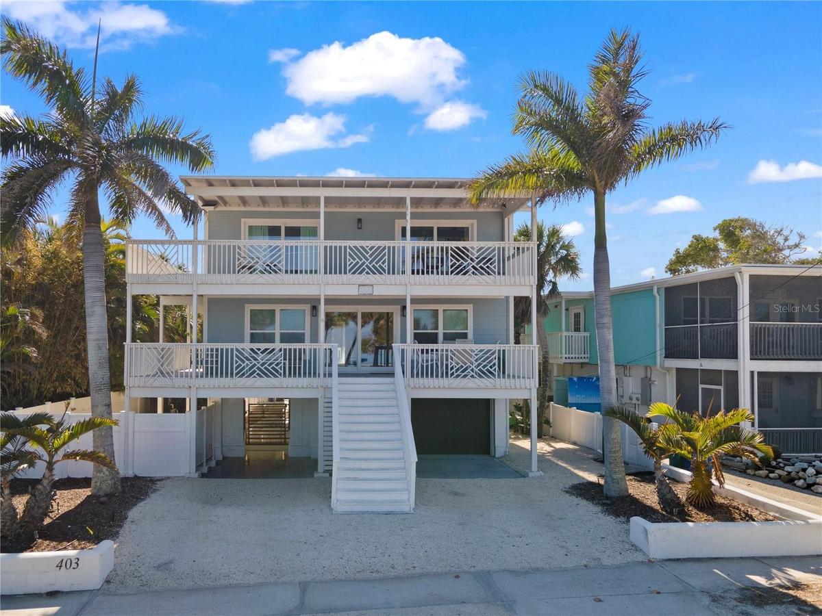 FRONT VIEW WITH POOL AREA ENTRANCE & GARAGE