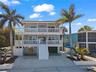 FRONT VIEW WITH POOL AREA ENTRANCE & GARAGE
