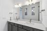 Beautiful primary bath with dual sinks, upgraded finishes, and everyday convenience.