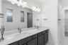 Beautiful primary bath with dual sinks, upgraded finishes, and everyday convenience.