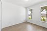 Bright flexible first floor bedroom with warm flooring and natural light for work, hobbies, or everyday use.