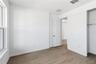 Spacious bedroom with a simple layout, bright walls, and flexible furniture options.