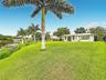 Side view of spacious size lot with palm tree