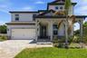 Welcoming exterior with a covered entry, stone accents, and a bright Florida feel.
