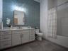 Hall Bathroom with tub and shower and double sinks