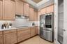 Virtually staged; partial view of the Kitchen featuring extensive counter space.