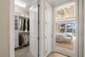Virtually staged; approaching Main Bedroom.