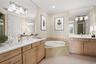 Virtually staged; Oversized, dual vanities, and large tub in Owner's Bath.