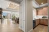Virtually staged; approaching Kitchen with Dining Room, Living Room and covered Terrace access.
