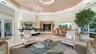 Soaring vaulted great room with a bar, dining, and lounge areas, seamlessly oriented to showcase the dramatic circular kitchen