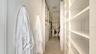 Spacious primary suite closet with custom built-in shelving for organization and style
