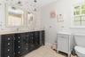 Double vanity with integrated sinks, light-toned countertop, and dual framed mirrors