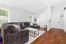 Accessory Unit Living area featuring hardwood flooring, multiple windows providing natural light, a vaulted ceiling, and white panel doors