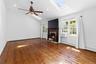 Spacious room featuring vaulted ceilings, fire place, recessed lighting, and rich wood-finish flooring