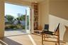 The living/dining room opens fully to the patio/yard through window doors, transforming the entire area into an outdoor extension ideal for gatherings
