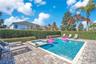 Resort-style screened pool area offering privacy, sunshine, and seamless indoor-outdoor living