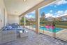 Spacious covered outdoor lounge area designed for shaded relaxation and year-round enjoyment
