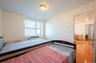 Bedroom featuring light wood-style flooring and a wall mounted AC
